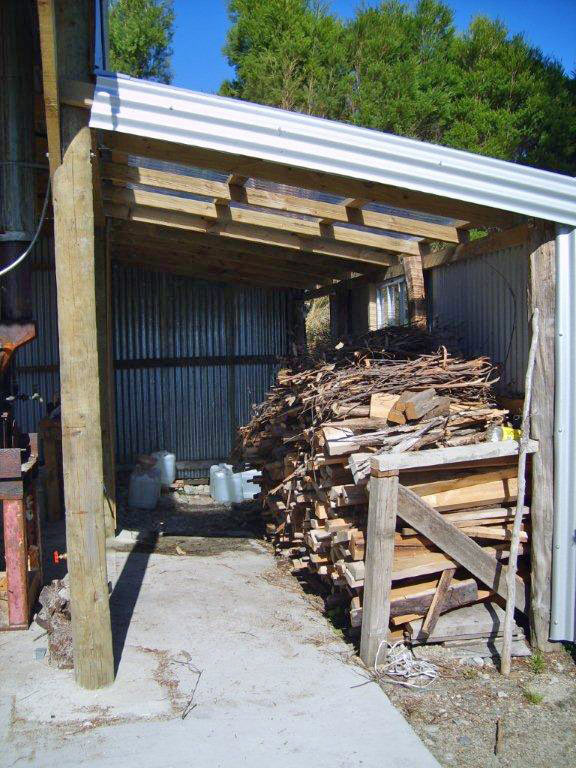 Wood stacked inside a woodshed next to bolier room